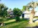 Charming one-story home featuring a brick facade, manicured landscaping, and mature palm trees at 131 Goodale Dr., Longs, SC 29568