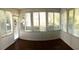 Enclosed sunroom with dark wood floors and an abundance of windows, creating a light and airy space at 131 Goodale Dr., Longs, SC 29568