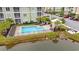 Aerial view of the community pool with chairs and nearby pond, enhancing the outdoor appeal at 144 Puffin Dr. # 2A, Pawleys Island, SC 29585