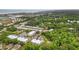 Aerial view showcasing a vibrant community with colorful buildings, surrounded by lush trees and a pond at 144 Puffin Dr. # 2A, Pawleys Island, SC 29585