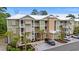 Aerial view shows the building's design, landscaping, and ample parking for residents and visitors at 144 Puffin Dr. # 2A, Pawleys Island, SC 29585