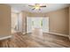 Spacious bedroom with wood floors and a ceiling fan and view to another room at 144 Puffin Dr. # 2A, Pawleys Island, SC 29585