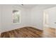 Bedroom with wood floors and view to the laundry room at 144 Puffin Dr. # 2A, Pawleys Island, SC 29585