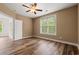 Bedroom with wood floor, ceiling fan, and a window bringing in plenty of natural light at 144 Puffin Dr. # 2A, Pawleys Island, SC 29585
