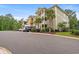 Well-maintained exterior showcasing multiple units, lush landscaping, and convenient parking at 144 Puffin Dr. # 2A, Pawleys Island, SC 29585