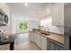 Updated kitchen features granite counters, white cabinets, stainless appliances, open to living area at 144 Puffin Dr. # 2A, Pawleys Island, SC 29585