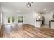 Open-concept living area flows into the kitchen, with hardwood floors, neutral walls, and natural light at 144 Puffin Dr. # 2A, Pawleys Island, SC 29585