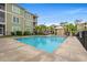 Community swimming pool with lounge chairs and well-maintained landscaping on a sunny day at 144 Puffin Dr. # 2A, Pawleys Island, SC 29585