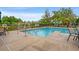 Community pool area with lounge chairs, a safety fence and a clear blue sky overhead at 144 Puffin Dr. # 2A, Pawleys Island, SC 29585