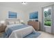 A stylish bedroom featuring a large bed, nightstands, and an exterior view through the window at 1590 Landing Rd., Myrtle Beach, SC 29577