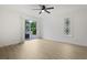 A bright bedroom includes wood floors, a modern ceiling fan, and sliding glass doors at 1590 Landing Rd., Myrtle Beach, SC 29577