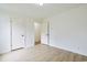 A bright room features a neutral wall color, and open doorway, and newly installed wood floors at 1590 Landing Rd., Myrtle Beach, SC 29577