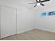 Bright bedroom features a ceiling fan, neutral paint, and closet at 1590 Landing Rd., Myrtle Beach, SC 29577
