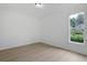 An empty room featuring wood floors, white walls, and an exterior view through the window at 1590 Landing Rd., Myrtle Beach, SC 29577