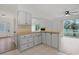 Well-lit kitchen with tile floors, cabinets, breakfast bar and view into living area at 1590 Landing Rd., Myrtle Beach, SC 29577