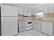 Galley-style kitchen featuring white appliances and cabinets at 1590 Landing Rd., Myrtle Beach, SC 29577