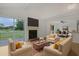 Bright living room featuring a fireplace, comfortable seating, and sliding glass doors with golf course view at 1590 Landing Rd., Myrtle Beach, SC 29577