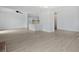 Spacious open-concept living area with light wood floors, ceiling fan, and adjacent kitchen at 1590 Landing Rd., Myrtle Beach, SC 29577