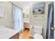 Bright bathroom featuring a bathtub with curtains, a vanity, and marine themed wall art adding to the decor at 17 South Oak Dr., Surfside Beach, SC 29575