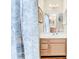 Bathroom vanity featuring stylish sink, faucet, and decor with coordinated mirror, lighting, and wall art at 17 South Oak Dr., Surfside Beach, SC 29575