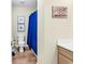 Bathroom featuring a toilet and a shower with a blue curtain, offering a tranquil and functional space at 17 South Oak Dr., Surfside Beach, SC 29575