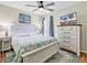 Comfortable bedroom with a ceiling fan, dresser with TV, and a queen bed with stylish coastal themed linens at 17 South Oak Dr., Surfside Beach, SC 29575