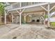 Under-house carport area with room for parking and storage, plus a grilling area at 17 South Oak Dr., Surfside Beach, SC 29575