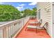 Inviting deck featuring comfortable lounge chairs and an outdoor dining table with wooded views at 17 South Oak Dr., Surfside Beach, SC 29575
