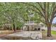 Exterior view of the home featuring a spacious driveway, well-maintained lawn, and mature trees at 17 South Oak Dr., Surfside Beach, SC 29575