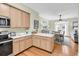 Well-lit kitchen with barstool seating at counter and view of living space at 17 South Oak Dr., Surfside Beach, SC 29575