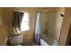 Basic bathroom showing a toilet, bathtub with shower, and a window with curtain at 1744 John St., Conway, SC 29527