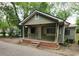 Modest home with olive green siding, a small front porch, and a brick stairway at 1744 John St., Conway, SC 29527