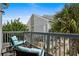 A cozy balcony has outdoor furniture with blue cushions and a pretty landscaped view at 1891 Colony Dr. # 15 J, Surfside Beach, SC 29575