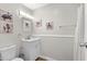 Bathroom with a single sink vanity with framed mirror and decorative artwork at 1891 Colony Dr. # 15 J, Surfside Beach, SC 29575