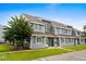 Well-maintained townhome featuring gray siding, blue shutters, and manicured landscaping, creating a welcoming curb appeal at 1891 Colony Dr. # 15 J, Surfside Beach, SC 29575