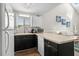 Open kitchen boasts ample counter space, white cabinetry, and a breakfast bar leading to the living area at 1891 Colony Dr. # 15 J, Surfside Beach, SC 29575