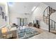 Bright living room with vaulted ceilings and a spiral staircase leading to a loft, creates an airy and inviting atmosphere at 1891 Colony Dr. # 15 J, Surfside Beach, SC 29575