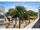 A serene pool area features palm trees, lounge chairs, and a beautiful pool at 1891 Colony Dr. # 15 J, Surfside Beach, SC 29575