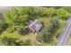 Aerial view showcasing house with mature trees next to a road and agricultural fields at 1895 Bucksville Dr., Conway, SC 29527