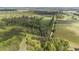 Expansive view of wooded property divided by a road next to large farmland and a building at 1895 Bucksville Dr., Conway, SC 29527
