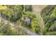 Aerial view of wooded property, with house nestled amongst trees near a quiet road at 1895 Bucksville Dr., Conway, SC 29527