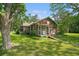 Charming one-story brick home with front porch and mature trees on a sunny lot at 1895 Bucksville Dr., Conway, SC 29527