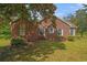 Rear view of a brick house showing classic architecture and a sprawling green lawn at 1895 Bucksville Dr., Conway, SC 29527