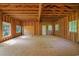 A large unfinished garage with exposed framing offers ample space for customization and design at 1895 Bucksville Dr., Conway, SC 29527