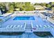 Community pool area with lounge chairs in fenced-in area with residential units in background at 191 Maison Dr. # B-123, Myrtle Beach, SC 29572