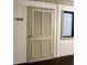 Image shows the apartment door of unit B-123 with a beige, louvered door and dark framed window at 191 Maison Dr. # B-123, Myrtle Beach, SC 29572