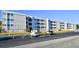 Spacious condo building featuring multiple floors, parking area, and balcony views at 191 Maison Dr. # B-123, Myrtle Beach, SC 29572