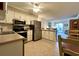 Open concept kitchen with stainless steel appliances seamlessly connects to the living area at 191 Maison Dr. # B-123, Myrtle Beach, SC 29572