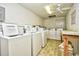 Well-lit laundry room featuring multiple washing machines, a ceiling fan, and linoleum tile flooring at 191 Maison Dr. # B-123, Myrtle Beach, SC 29572