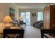 Inviting living room featuring a comfortable sofa, stylish armchair, and sliding glass doors to a balcony at 191 Maison Dr. # B-123, Myrtle Beach, SC 29572